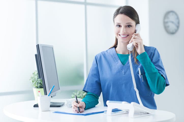 Receptionist enjoying plastic surgery marketing leads.